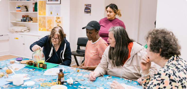 Group of residents taking part in a craft activity at a community class