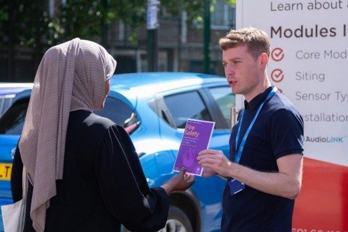 Building safety manager on site talking to a resident 