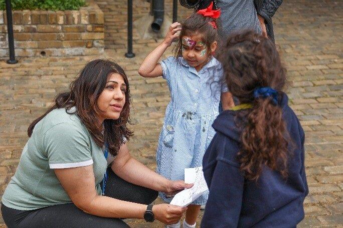 Building safety manager on site talking to children