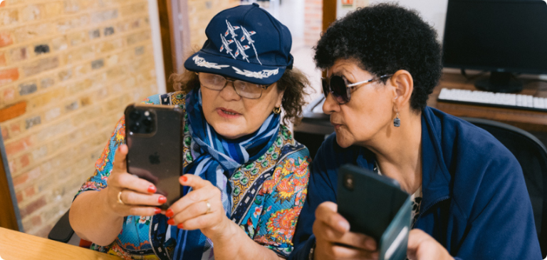 Two women using smartphones during a digital skills session
