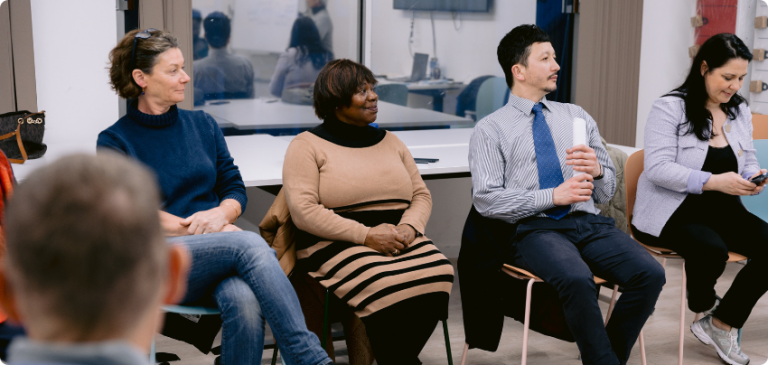 Group of residents sitting in a circle during a workshop
