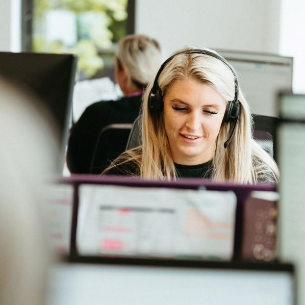 Customer service staff member wearing a headset at a call centre