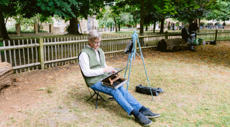 Resident sketching outdoors in a park