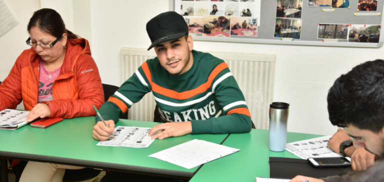 Learners writing during a community class