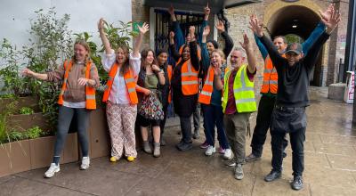Nine residents and council staff celebrating  their project outside of Latimer Road Underground station